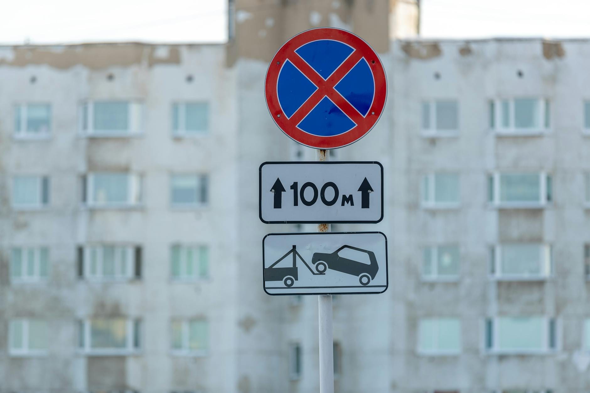 Znak zakazu parkowania przed starą kamienicą w mieście